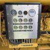 Engine-mounted gauge panel on a Caterpillar 3516C diesel generator showing multiple analog and digital gauges.