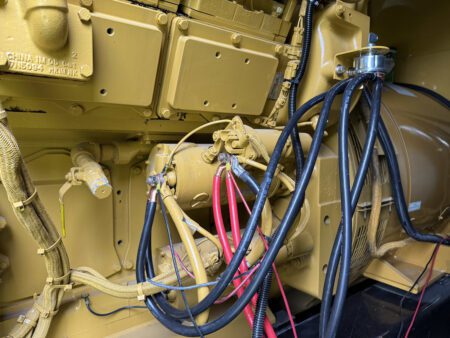 Caterpillar 3516C diesel generator starter motor assembly with wiring connections.