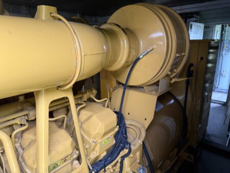 Caterpillar 3516C engine air intake and filtration system connected to generator end.