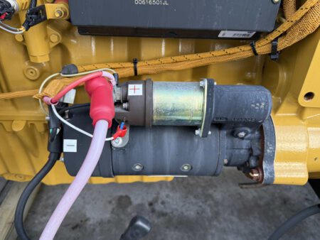Caterpillar generator starter motor with connected wiring.