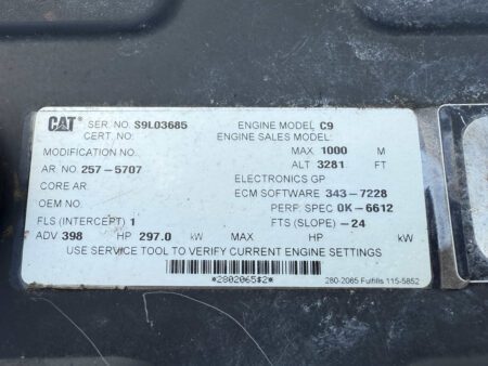 Caterpillar C9 ACERT engine data tag showing model, serial number, and performance specifications.