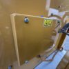 Close-up of Caterpillar generator electrical junction box with safety warning label.