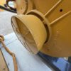 Close-up of Caterpillar generator end housing with protective cover.