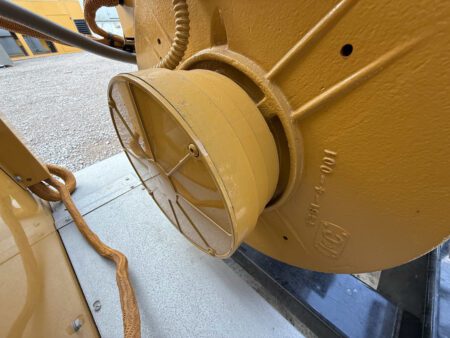 Close-up of Caterpillar generator end housing with protective cover.