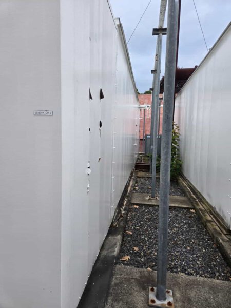 Side view of CAT generator enclosure labeled “Generator 2” with visible wear on the panel.