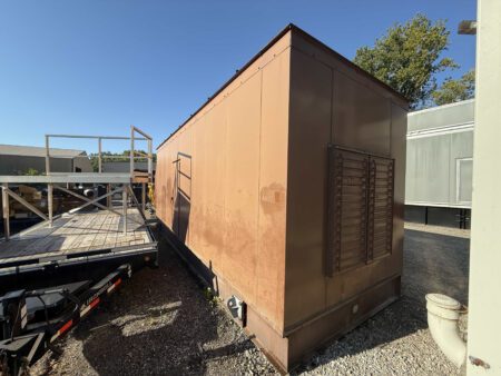 Rear-left corner of Caterpillar generator enclosure with radiator discharge opening