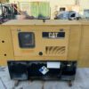 Front view of Caterpillar C4.4 generator enclosure with doors closed.