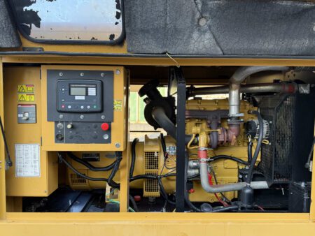 Front interior of Caterpillar C4.4 generator enclosure with engine visible.