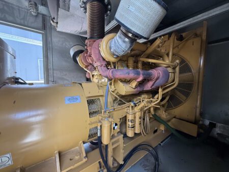 Side view of Caterpillar 3412 engine with alternator housing and fuel filters.