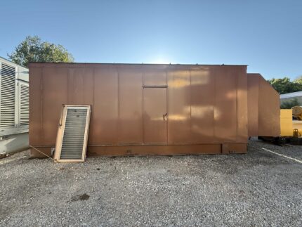 Full front view of Caterpillar generator enclosure in brown finish